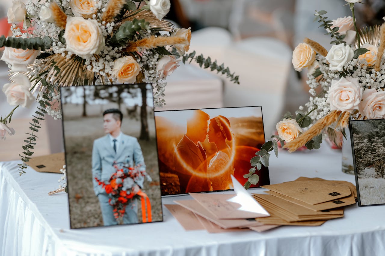 Creative composition with small bouquets of flowers and photos near gift envelopes in daylight